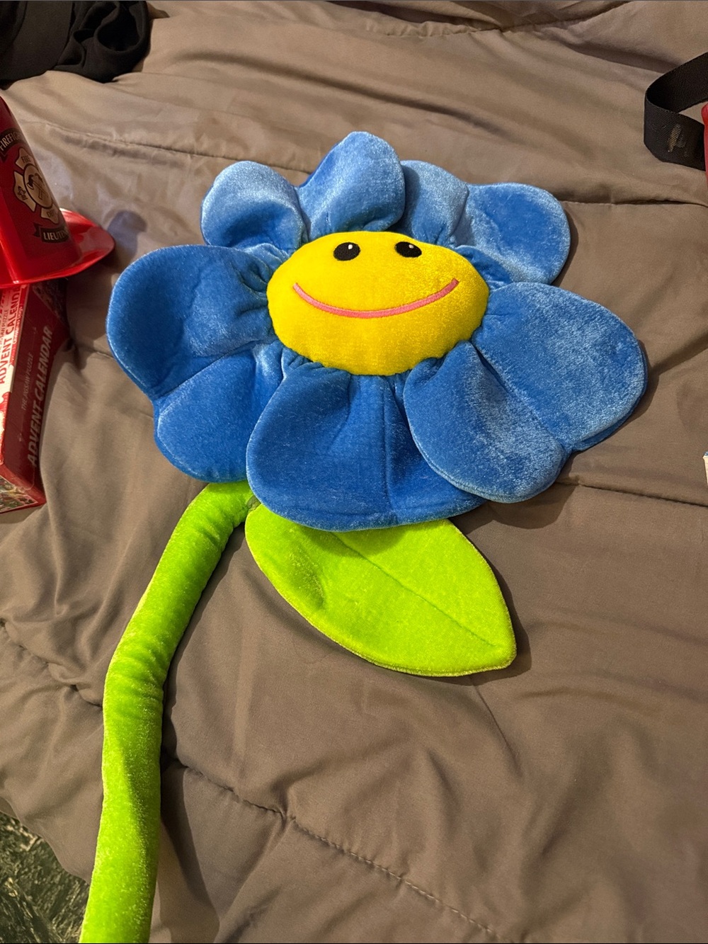 Fiesta Blue Plush Smiling Flower with Yellow Face and Green Stem